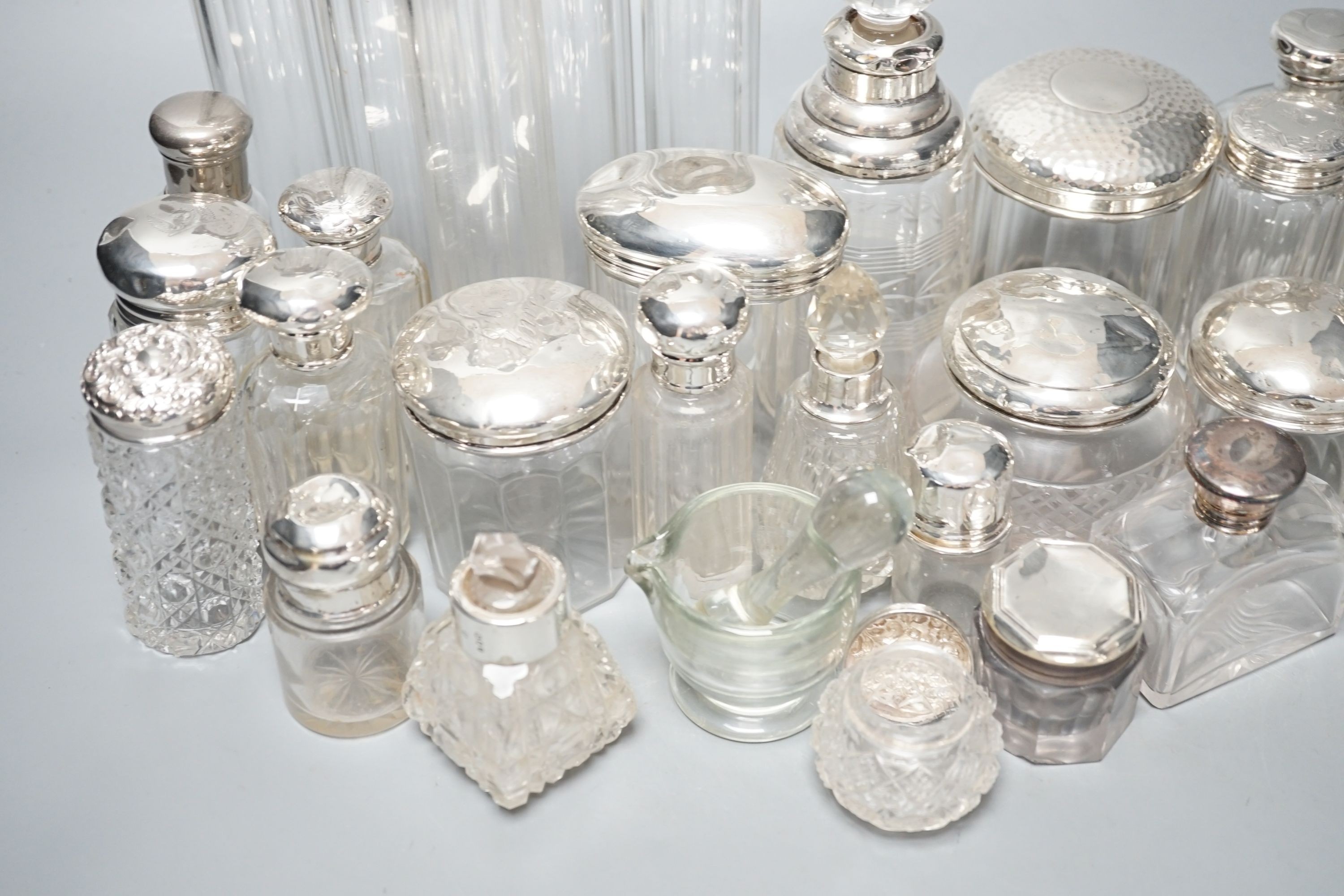 A collection of assorted mainly silver-capped scent bottles and toilet bottles.